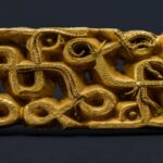 A man walking through the forest stumbled upon a gold sword, hidden beneath a tree for centuries