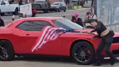 Anti-ICE protester waving upside-down US flag hit by car in New Jersey, video shows her being thrown to the ground