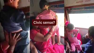 Mother holds child out of moving train window to urinate; video sparks debate on civic sense and child safety during travel |