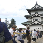 1,000 people in Japan join forces to pull a 400-ton castle keep back toward its original position after it was moved 78 meters for repairs