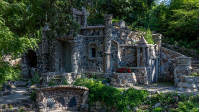 In 1932, an Ohio foundry worker lost his job and began building a rock garden; he spent 12 years creating hundreds of structures, and his wife preserved it for another 53 years