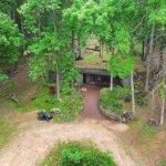 A Missouri engineer bought remote Ozarks land in 1970 and slowly built a reinforced-concrete home into the hillside; more than 50 years later, his son is restoring it room by room