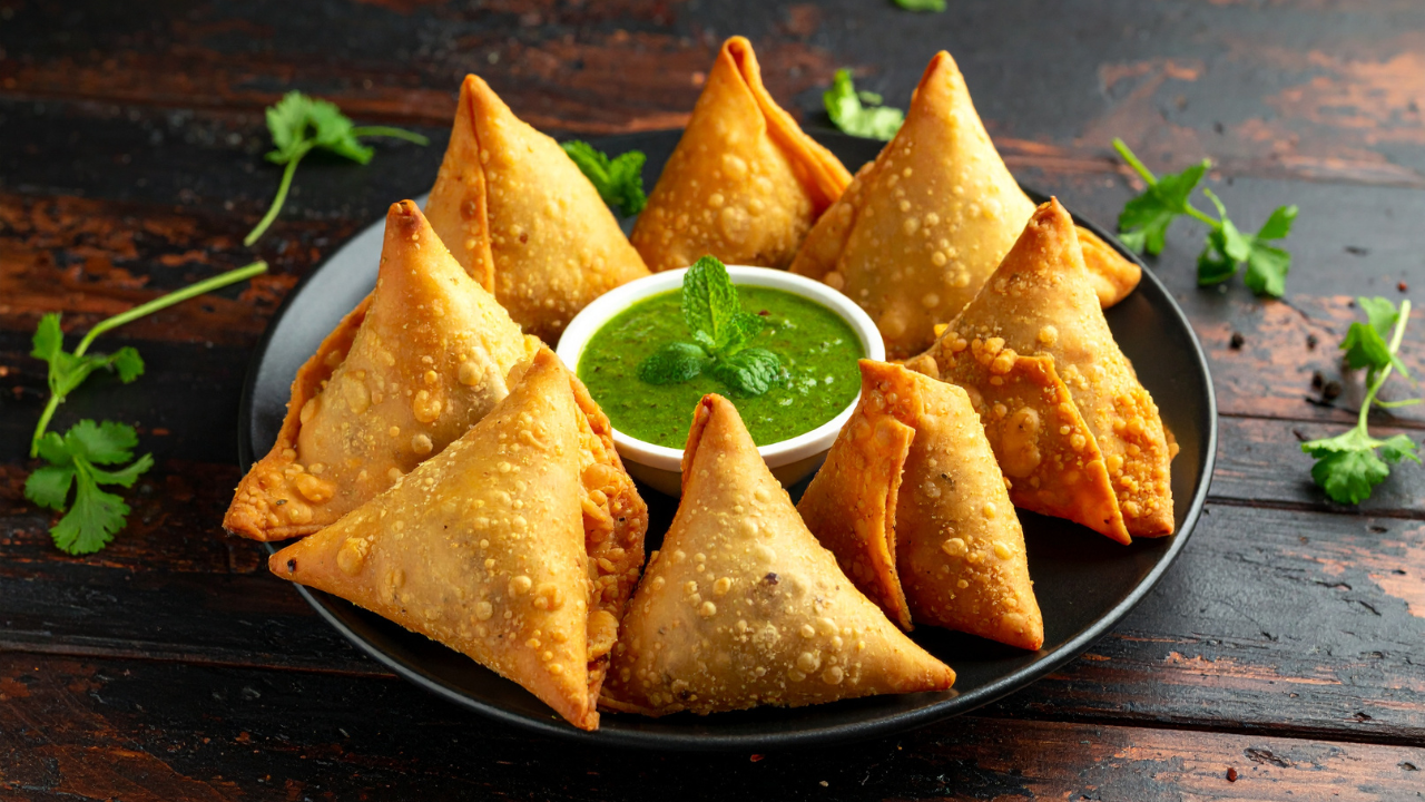 How did samosa become an Indian favourite despite not originating in India?