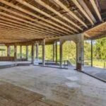 In 1994, Hollywood Video’s founder bought 32 Oregon acres for $1.25 million and began a 52,000-sq-ft mansion; nearly 30 years and 3 owners later, it is still unfinished and asking $4.7 million