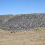 In 2002, Idaho buried nearly 300 tons of crushed waste glass beneath Highway 75; the material formed 8 to 12 inches of fill under a 200-foot road section