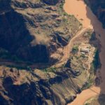 Three women were caught in a deadly Grand Canyon flash flood and clung to a rock ledge for 5 hours; after briefly believing each other had been swept away, a helicopter found them alive